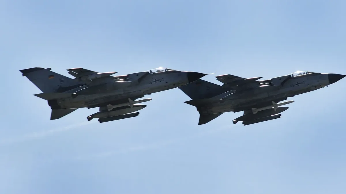 Two Luftwaffe Tornado ECR electronic-combat aircraft in flight against a clear sky.