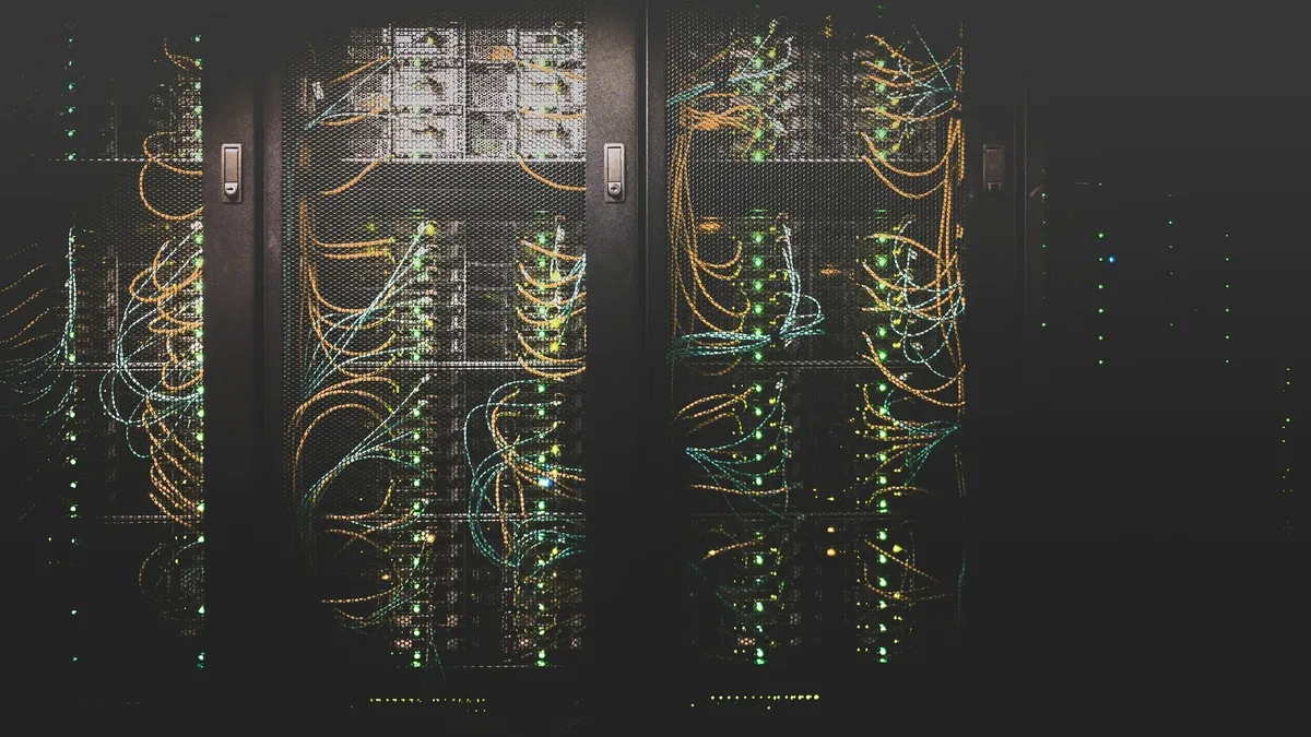 A data-centre aisle with racks of structured network cabling.